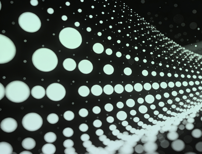 A graphic showing light green dots of different sizes in a pattern